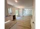 Open-concept kitchen featuring white cabinets and modern appliances, seamlessly flowing into the dining and living areas at 66 Pine Creek Ct, Dallas, GA 30157