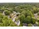 An aerial view of a neighborhood with mature trees and well-maintained homes at 1981 Sumter Ct, Lawrenceville, GA 30044
