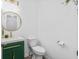 Powder room featuring a modern vanity, round mirror, and decorative green cabinet at 1981 Sumter Ct, Lawrenceville, GA 30044