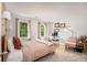 Bedroom with multiple windows, light colored walls, and a comfortable sitting area at 1981 Sumter Ct, Lawrenceville, GA 30044