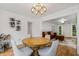 Dining area with a round table, chairs, bay windows, hardwood floors, and view into living room at 1981 Sumter Ct, Lawrenceville, GA 30044