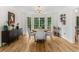 Dining area with a round table, chairs, bay windows, hardwood floors, and bar cart at 1981 Sumter Ct, Lawrenceville, GA 30044
