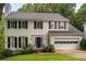 Charming two-story home with black shutters, a landscaped yard, and an attached two-car garage at 1981 Sumter Ct, Lawrenceville, GA 30044