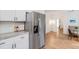 Close-up view of kitchen features including stainless refrigerator, white cabinets and granite countertops at 1981 Sumter Ct, Lawrenceville, GA 30044