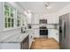 Bright kitchen features stainless steel appliances, granite countertops, undermount sink and white cabinets at 1981 Sumter Ct, Lawrenceville, GA 30044
