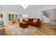 Inviting living room with a brick fireplace, hardwood floors, and a view into the dining area at 1981 Sumter Ct, Lawrenceville, GA 30044