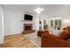 Inviting living room with a brick fireplace, hardwood floors, and a view into the dining area at 1981 Sumter Ct, Lawrenceville, GA 30044