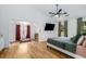 Spacious main bedroom features an en-suite sitting area and ceiling fan at 1981 Sumter Ct, Lawrenceville, GA 30044