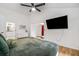 A well-lit main bedroom with an adjacent area, vaulted ceilings, and a ceiling fan at 1981 Sumter Ct, Lawrenceville, GA 30044