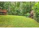 Expansive backyard with a play structure, swing set, and lush lawn, ideal for Gathering fun and outdoor activities at 2210 Chrysler Ne Ter, Atlanta, GA 30345