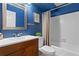 Bathroom with a blue wall, vanity, and a shower and bath combination with white tiles at 2210 Chrysler Ne Ter, Atlanta, GA 30345