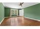 Bedroom featuring hardwood floors, green walls, a ceiling fan, and natural light at 2210 Chrysler Ne Ter, Atlanta, GA 30345