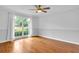 Bedroom with hardwood floors and a large window allowing natural light at 2210 Chrysler Ne Ter, Atlanta, GA 30345