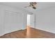 Bright bedroom featuring hardwood floors, ceiling fan, and closet with louvered doors at 2210 Chrysler Ne Ter, Atlanta, GA 30345