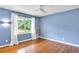 Bedroom with hardwood floors, large window, and blue walls at 2210 Chrysler Ne Ter, Atlanta, GA 30345