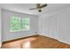 Bright bedroom featuring hardwood floors, ceiling fan, and closet with louvered doors at 2210 Chrysler Ne Ter, Atlanta, GA 30345