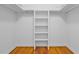 Walk-in closet with built-in shelving and hardwood floors at 2210 Chrysler Ne Ter, Atlanta, GA 30345
