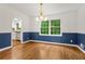 Dining room features chair rail, modern lighting and hardwood floors, adjacent to updated kitchen at 2210 Chrysler Ne Ter, Atlanta, GA 30345