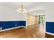 Bright dining room featuring chair rail, modern lighting and hardwood floors, connecting to living space at 2210 Chrysler Ne Ter, Atlanta, GA 30345
