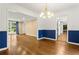 Open dining room area featuring chair rail, modern lighting and hardwood floors, connects to kitchen at 2210 Chrysler Ne Ter, Atlanta, GA 30345