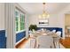 Stylish dining room with a bright window, elegant chandelier, and seating for six, perfect for gatherings at 2210 Chrysler Ne Ter, Atlanta, GA 30345