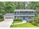 Charming two-story blue home featuring a spacious front yard and a two-car garage at 2210 Chrysler Ne Ter, Atlanta, GA 30345