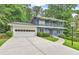 Charming two-story blue home featuring a spacious front yard, a two-car garage and balcony at 2210 Chrysler Ne Ter, Atlanta, GA 30345