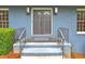 Close up shot of front door with dual sconces and stairs leading to the entry at 2210 Chrysler Ne Ter, Atlanta, GA 30345