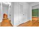 Hallway with hardwood floors, white walls, and a linen closet at 2210 Chrysler Ne Ter, Atlanta, GA 30345