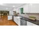 Charming kitchen featuring white cabinets, granite countertops, stainless steel appliances, and open to living space at 2210 Chrysler Ne Ter, Atlanta, GA 30345