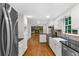 Updated kitchen boasts stainless steel appliances, granite countertops, a farmhouse sink, and open to living area at 2210 Chrysler Ne Ter, Atlanta, GA 30345