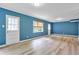 Spacious living room featuring new laminate flooring, windows, and doors that provide natural light at 2210 Chrysler Ne Ter, Atlanta, GA 30345
