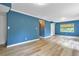 Spacious living room featuring new laminate flooring, windows, and doors that provide natural light at 2210 Chrysler Ne Ter, Atlanta, GA 30345