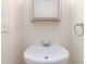 Small powder room with a pedestal sink and silver framed mirror at 2735 Sudbury Trce, Norcross, GA 30071