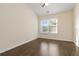 Sunny bedroom featuring a ceiling fan, large window, and hardwood floors at 2735 Sudbury Trce, Norcross, GA 30071