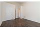 Empty bedroom featuring wood floors, neutral paint, and ensuite access at 2735 Sudbury Trce, Norcross, GA 30071