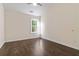 Cozy bedroom featuring a ceiling fan, large window, and hardwood floors at 2735 Sudbury Trce, Norcross, GA 30071