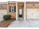 Front entrance with a black front door, white trim and a one car garage at 2735 Sudbury Trce, Norcross, GA 30071