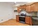 Well-lit kitchen features wood cabinets, stainless steel appliances, and granite countertops at 2735 Sudbury Trce, Norcross, GA 30071