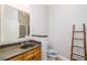 Well-lit bathroom featuring a sink, toilet, and a decorative bamboo ladder at 11 Perimeter E Ctr # 1412, Atlanta, GA 30346