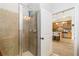 Tile shower with an open door that shows a view of the kitchen at 11 Perimeter E Ctr # 1412, Atlanta, GA 30346