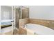 Bright bathroom showcasing a soaking tub and a glass-enclosed shower for a spa-like experience at 11 Perimeter E Ctr # 1412, Atlanta, GA 30346