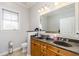 Bathroom featuring double sinks with a granite countertop and ample lighting at 11 Perimeter E Ctr # 1412, Atlanta, GA 30346