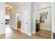 Bright hallway with hardwood floors, neutral walls, and convenient access to office, bathroom, and coat closet at 11 Perimeter E Ctr # 1412, Atlanta, GA 30346