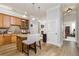 Open kitchen with wooden cabinets, granite countertops, stainless appliances, island seating, and seamless flow to living areas at 11 Perimeter E Ctr # 1412, Atlanta, GA 30346