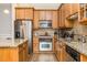 Well-appointed kitchen features granite counters, wood cabinets, and stainless steel appliances for cooking and entertaining at 11 Perimeter E Ctr # 1412, Atlanta, GA 30346
