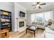 Cozy living room features neutral walls, fireplace, hardwood floors, and large windows creating a comfortable gathering space at 11 Perimeter E Ctr # 1412, Atlanta, GA 30346