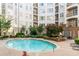 Beautiful in-ground pool with brick trim, seating area, and lush landscaping in a lovely residential neighborhood at 11 Perimeter E Ctr # 1412, Atlanta, GA 30346