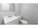 Clean half bathroom features a white vanity with sink, a mirrored medicine cabinet, and a toilet at 135 Pheasant Se Dr, Marietta, GA 30067