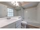 Bathroom featuring white vanity, sink, toilet, mirror and tub/shower combo at 135 Pheasant Se Dr, Marietta, GA 30067